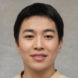 Joyful asian young-adult male with short  black hair and brown eyes