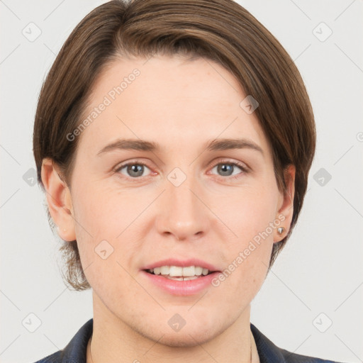 Joyful white young-adult female with short  brown hair and grey eyes