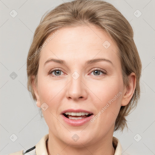 Joyful white adult female with medium  brown hair and grey eyes