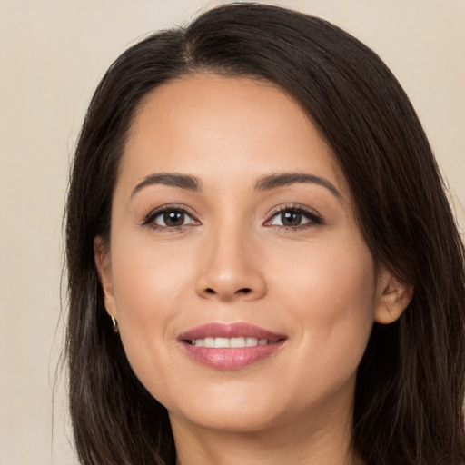 Joyful white young-adult female with long  brown hair and brown eyes