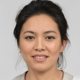 Joyful asian young-adult female with medium  brown hair and brown eyes