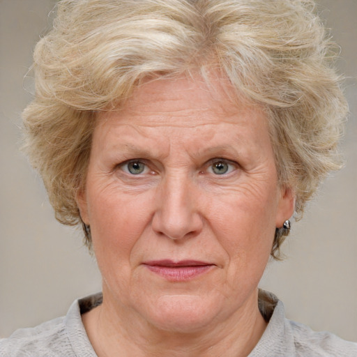 Joyful white middle-aged female with medium  blond hair and blue eyes