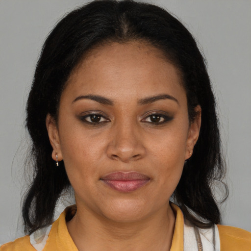 Joyful latino adult female with medium  brown hair and brown eyes