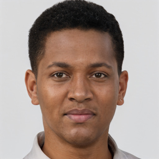 Joyful black young-adult male with short  brown hair and brown eyes