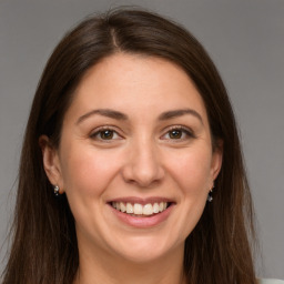 Joyful white young-adult female with long  brown hair and grey eyes