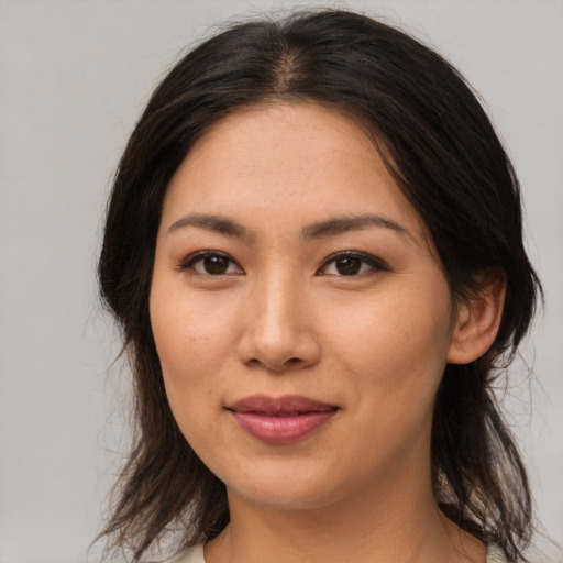 Joyful asian young-adult female with medium  brown hair and brown eyes