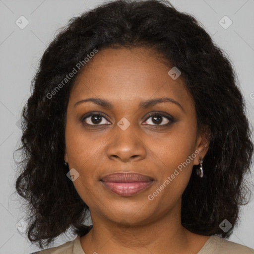 Joyful black young-adult female with long  brown hair and brown eyes