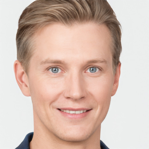 Joyful white young-adult male with short  brown hair and grey eyes