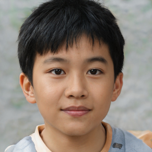 Joyful asian child male with short  brown hair and brown eyes
