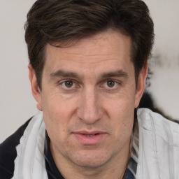 Joyful white adult male with short  brown hair and brown eyes