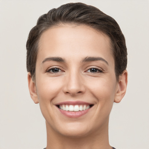 Joyful white young-adult female with short  brown hair and brown eyes