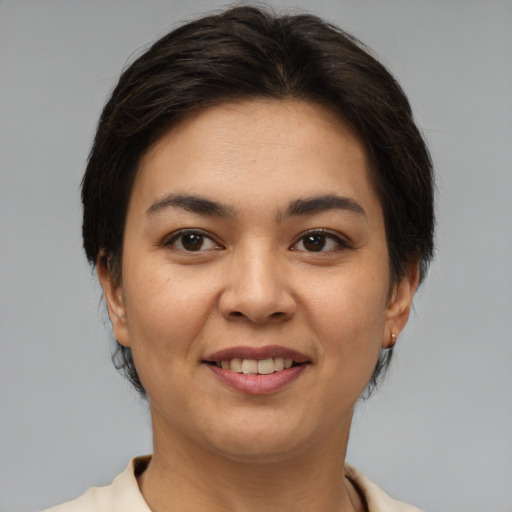 Joyful latino young-adult female with short  brown hair and brown eyes