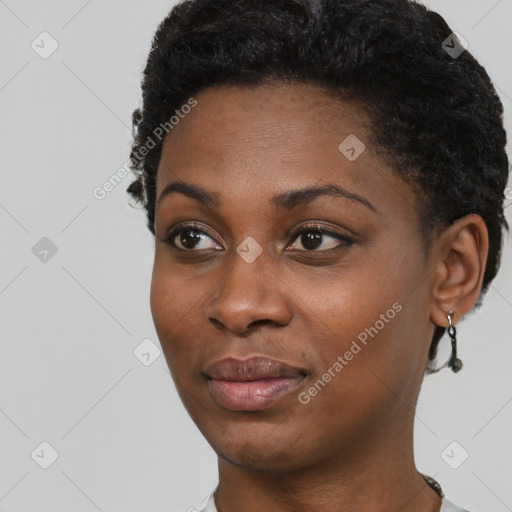 Joyful black young-adult female with short  black hair and brown eyes