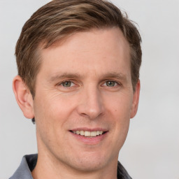 Joyful white adult male with short  brown hair and grey eyes