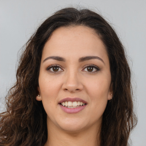 Joyful white young-adult female with long  brown hair and brown eyes