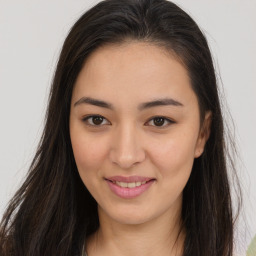 Joyful asian young-adult female with long  brown hair and brown eyes