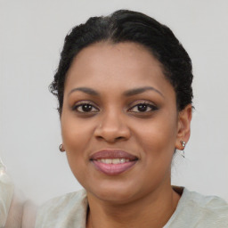 Joyful black young-adult female with short  black hair and brown eyes