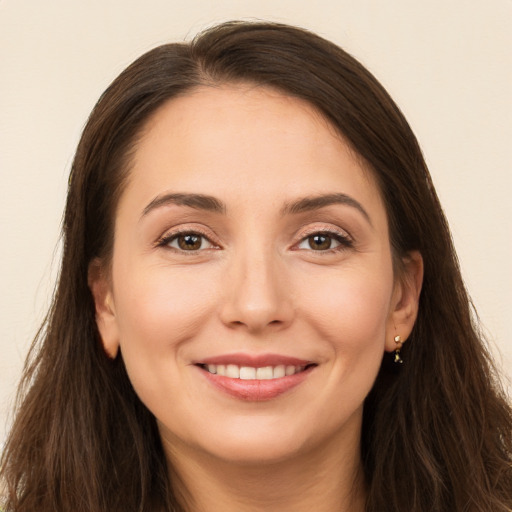 Joyful white young-adult female with long  brown hair and brown eyes