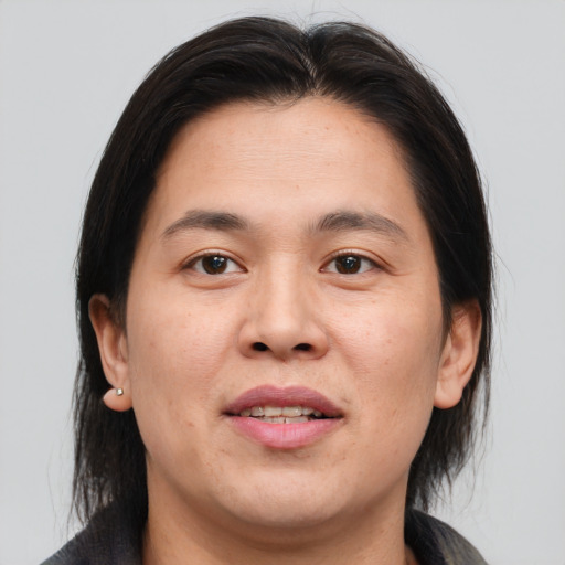 Joyful asian young-adult male with medium  brown hair and brown eyes