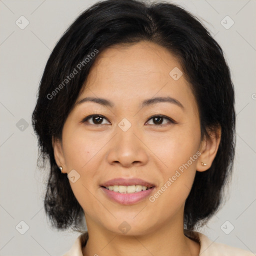 Joyful asian adult female with medium  brown hair and brown eyes