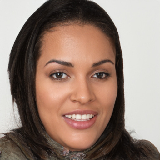 Joyful latino young-adult female with long  brown hair and brown eyes