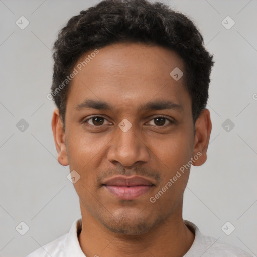 Joyful black young-adult male with short  black hair and brown eyes