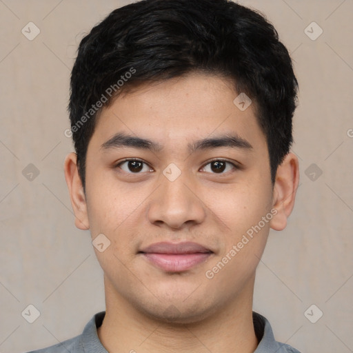 Joyful white young-adult male with short  black hair and brown eyes