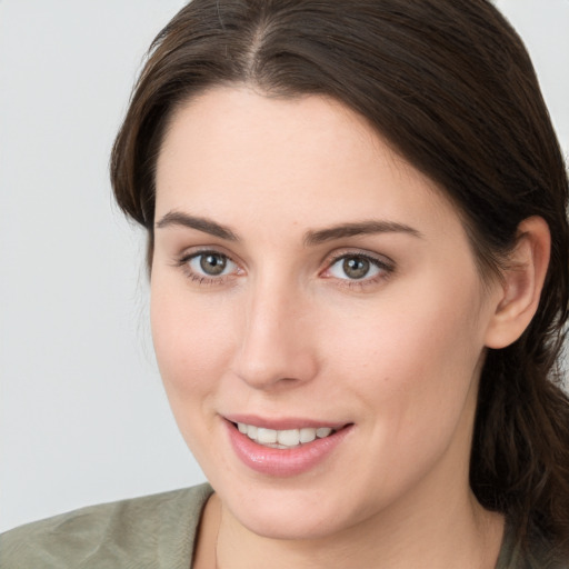 Joyful white young-adult female with medium  brown hair and grey eyes