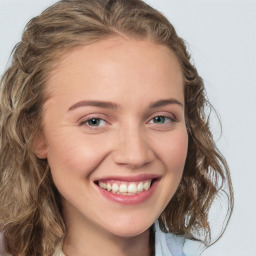 Joyful white young-adult female with medium  brown hair and green eyes