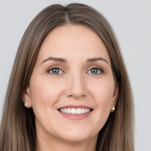 Joyful white young-adult female with long  brown hair and grey eyes