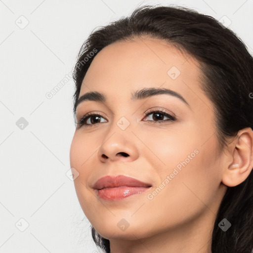 Joyful latino young-adult female with long  black hair and brown eyes