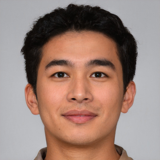Joyful asian young-adult male with short  black hair and brown eyes
