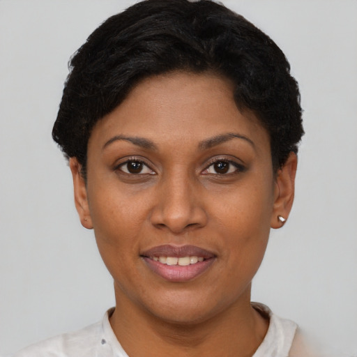 Joyful latino young-adult female with short  brown hair and brown eyes