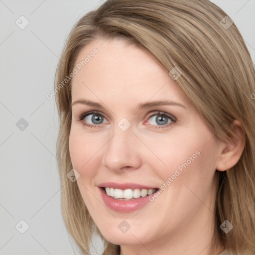 Joyful white young-adult female with long  brown hair and blue eyes