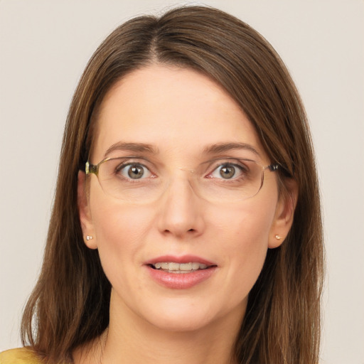 Joyful white young-adult female with long  brown hair and green eyes