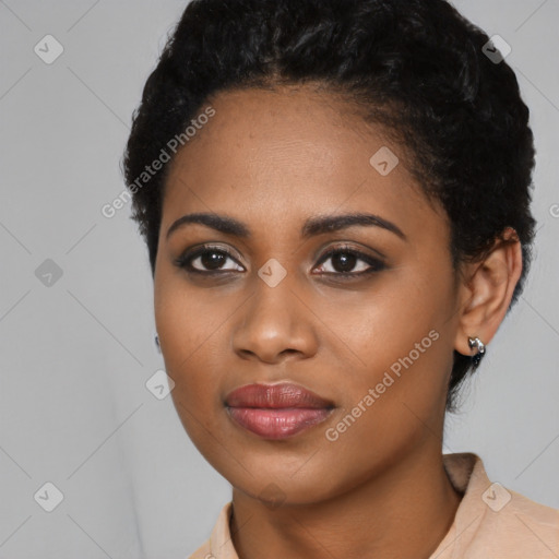 Joyful black young-adult female with short  black hair and brown eyes