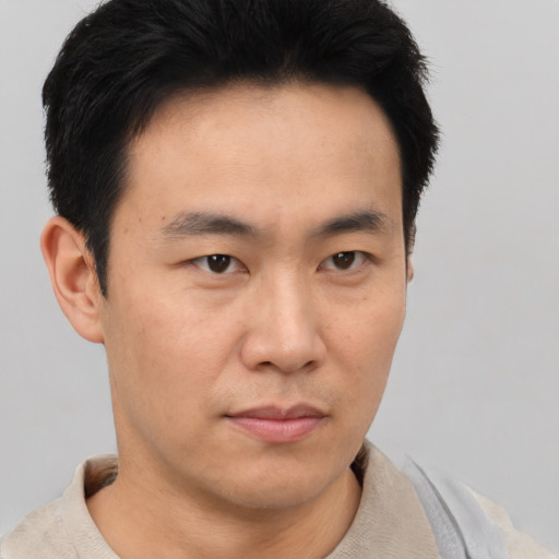 Neutral asian young-adult male with short  brown hair and brown eyes