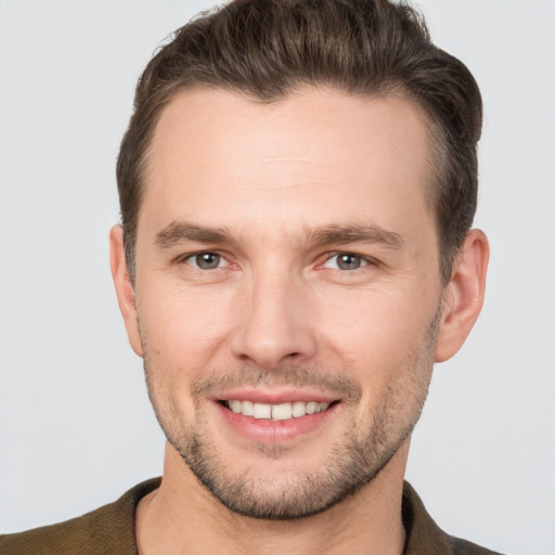 Joyful white young-adult male with short  brown hair and brown eyes