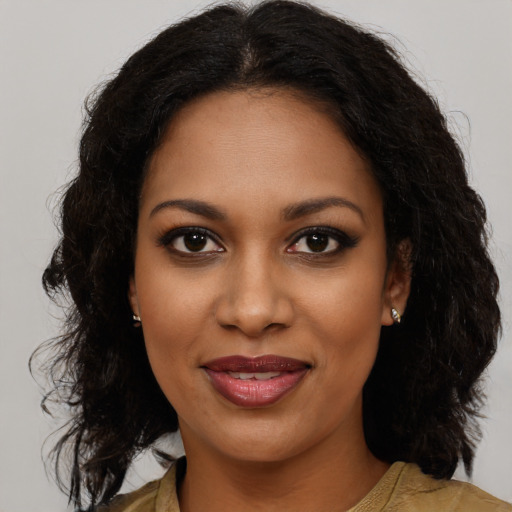 Joyful black young-adult female with medium  brown hair and brown eyes