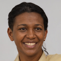 Joyful black adult female with short  brown hair and brown eyes