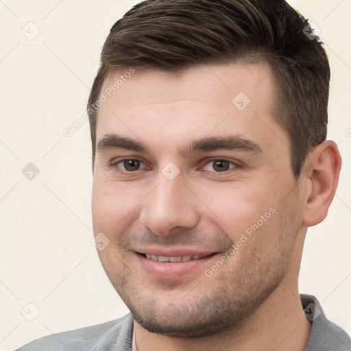 Joyful white young-adult male with short  brown hair and brown eyes