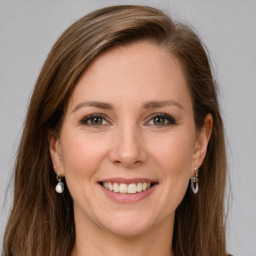 Joyful white young-adult female with long  brown hair and green eyes