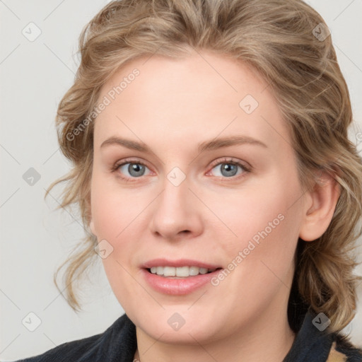 Joyful white young-adult female with medium  brown hair and blue eyes