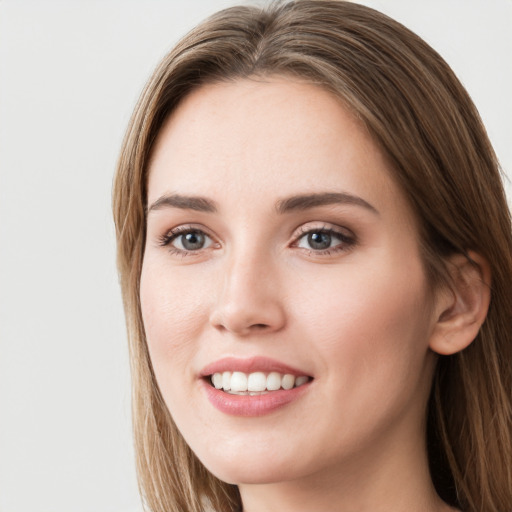 Joyful white young-adult female with long  brown hair and blue eyes