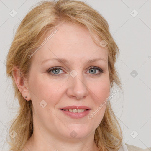 Joyful white adult female with medium  brown hair and blue eyes