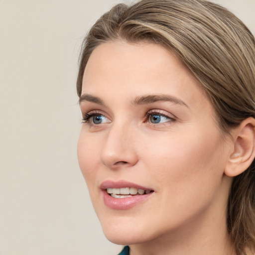 Joyful white young-adult female with long  brown hair and blue eyes