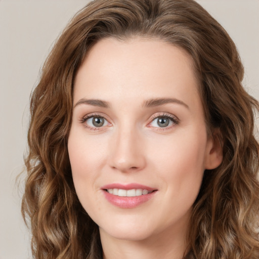 Joyful white young-adult female with long  brown hair and green eyes