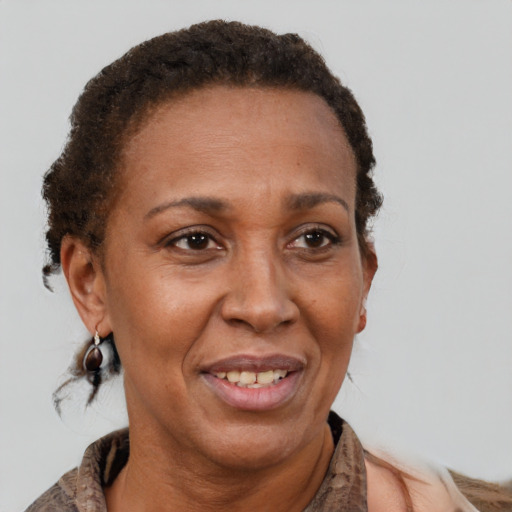 Joyful black adult female with short  brown hair and brown eyes