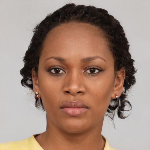 Neutral black young-adult female with medium  brown hair and brown eyes