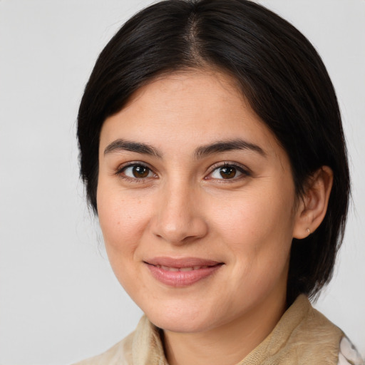 Joyful latino young-adult female with medium  brown hair and brown eyes